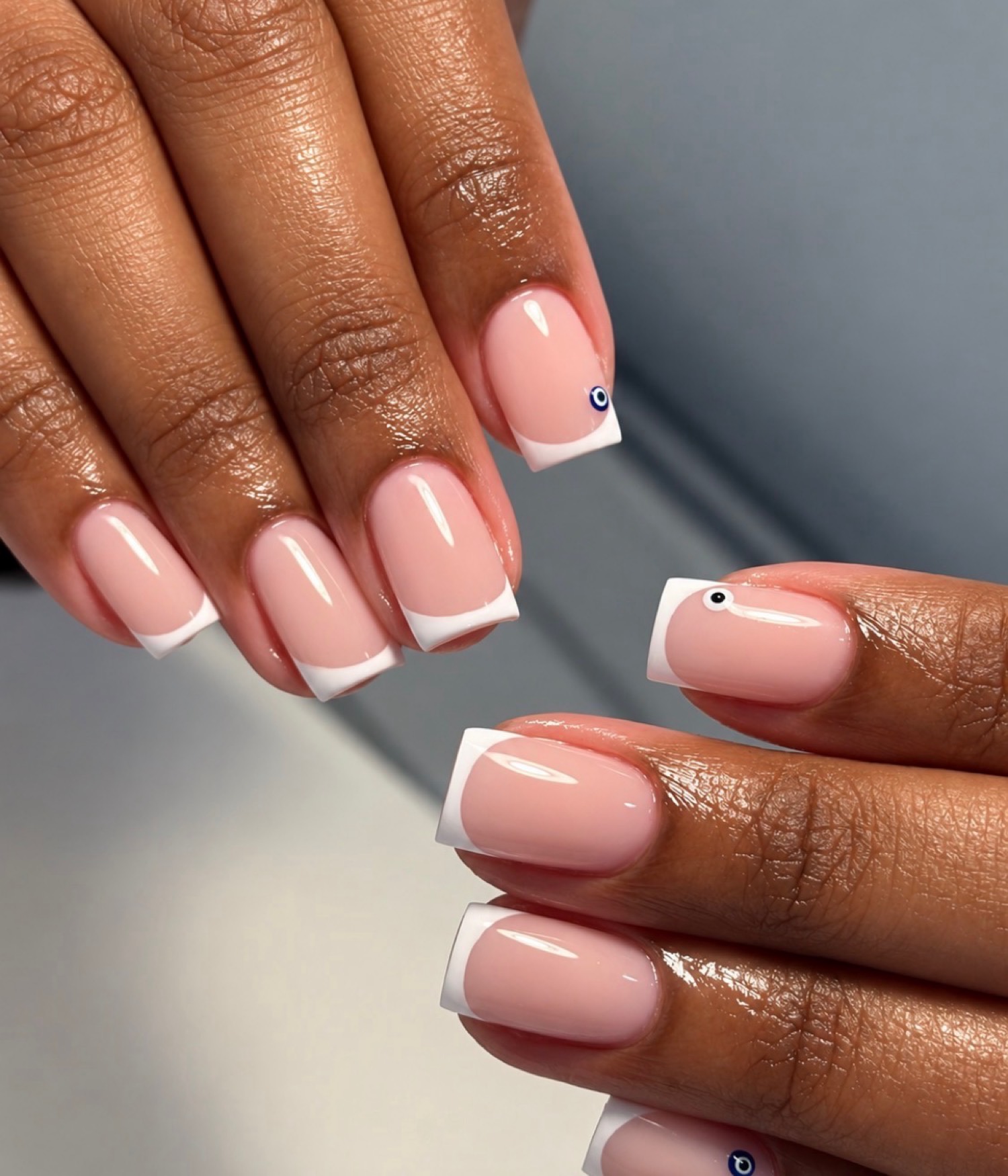 French + evil eye classic nails by Nelly Nails NY in East Williamsburg, Brooklyn